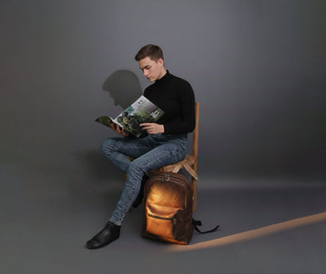 Man with a brown leather backpack in an everyday work setting