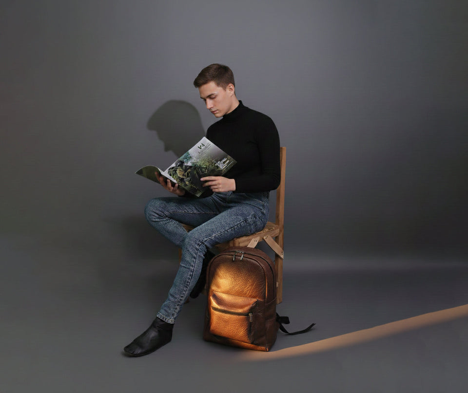 Man with a brown leather backpack in an everyday work setting