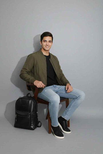 Man sitting with a Splash30 backpack in an everyday setting