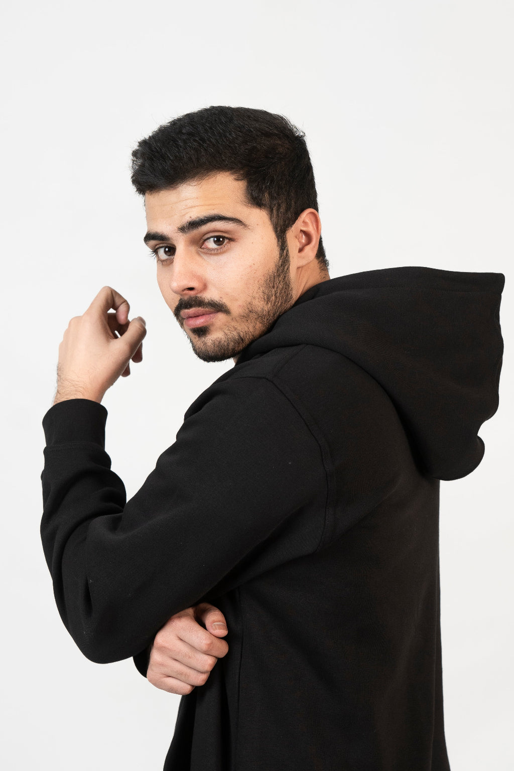 Man wearing a black hoodie against a white background