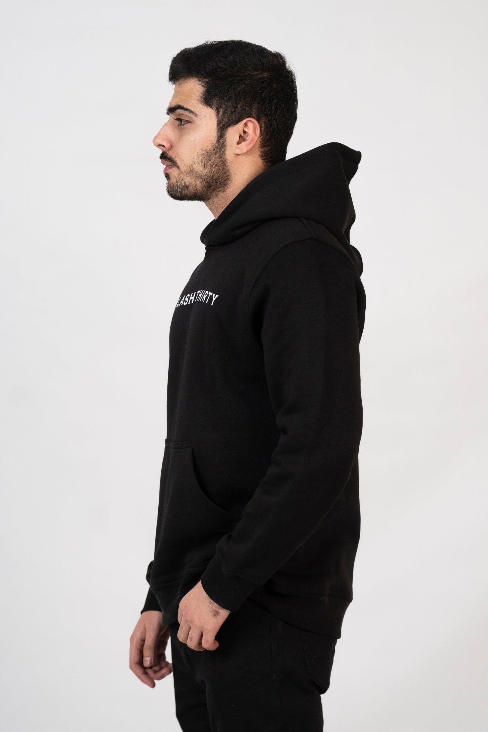 Man wearing a black hoodie with text on a white background