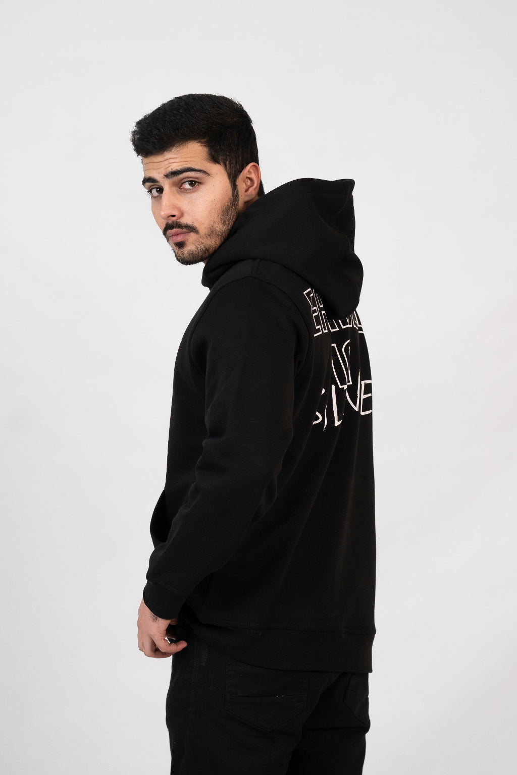 Man wearing a black hoodie with text on the back against a white background