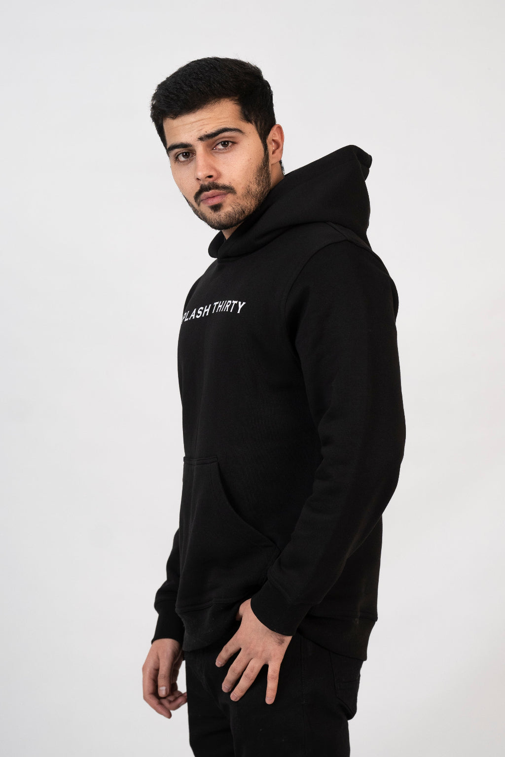 Man wearing a black hoodie with text on a white background