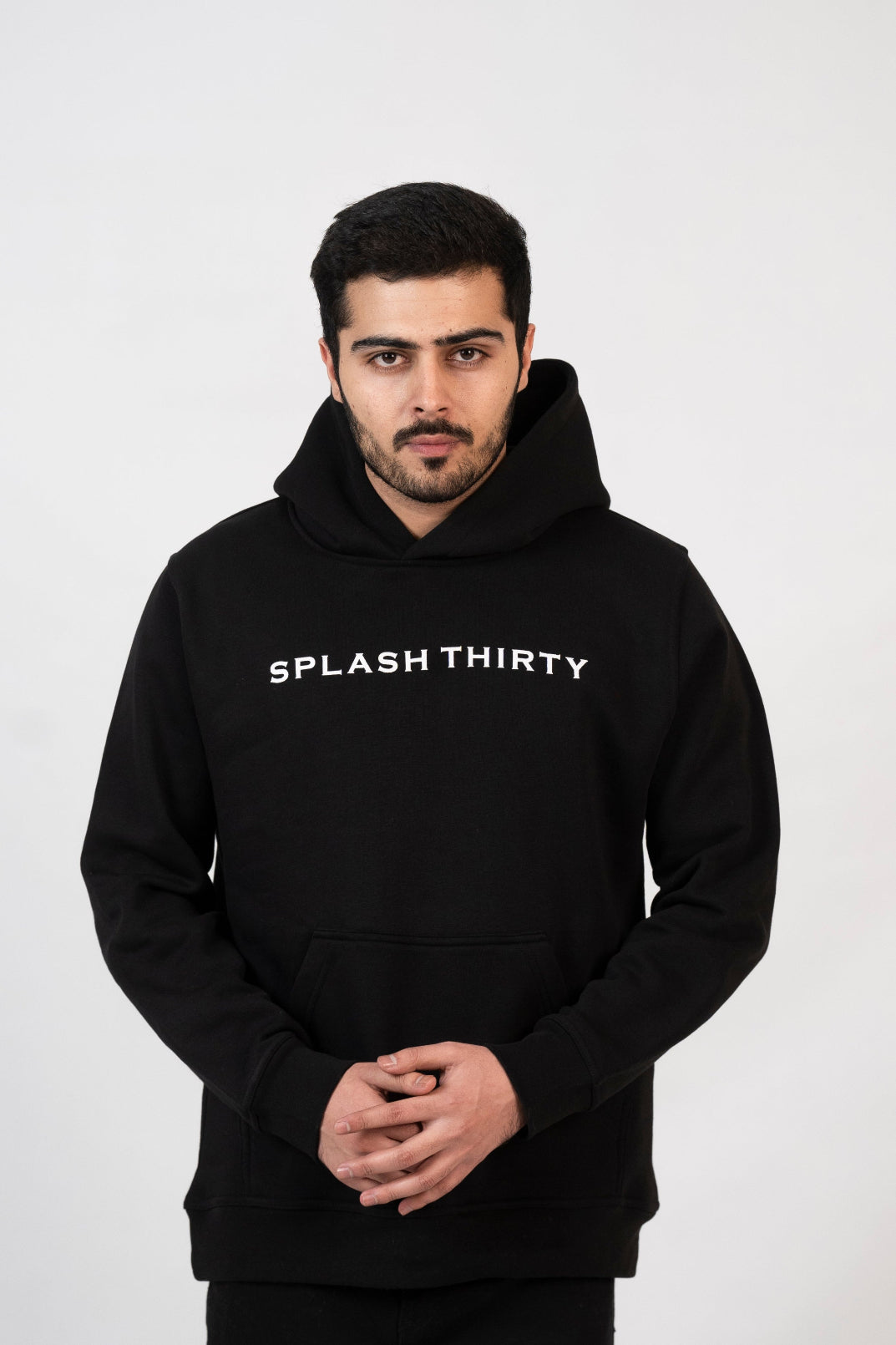 Man wearing a black hoodie with 'Splash Thirty' text on a white background