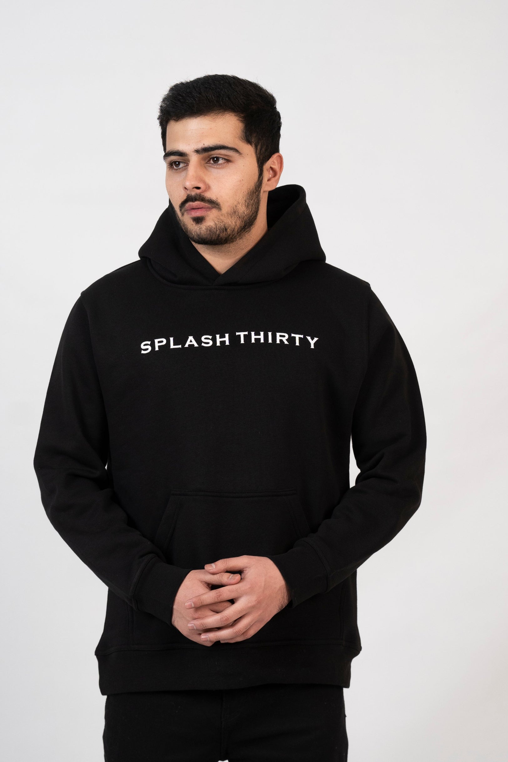Man wearing a black hoodie with 'Splash Thirty' text on a white background