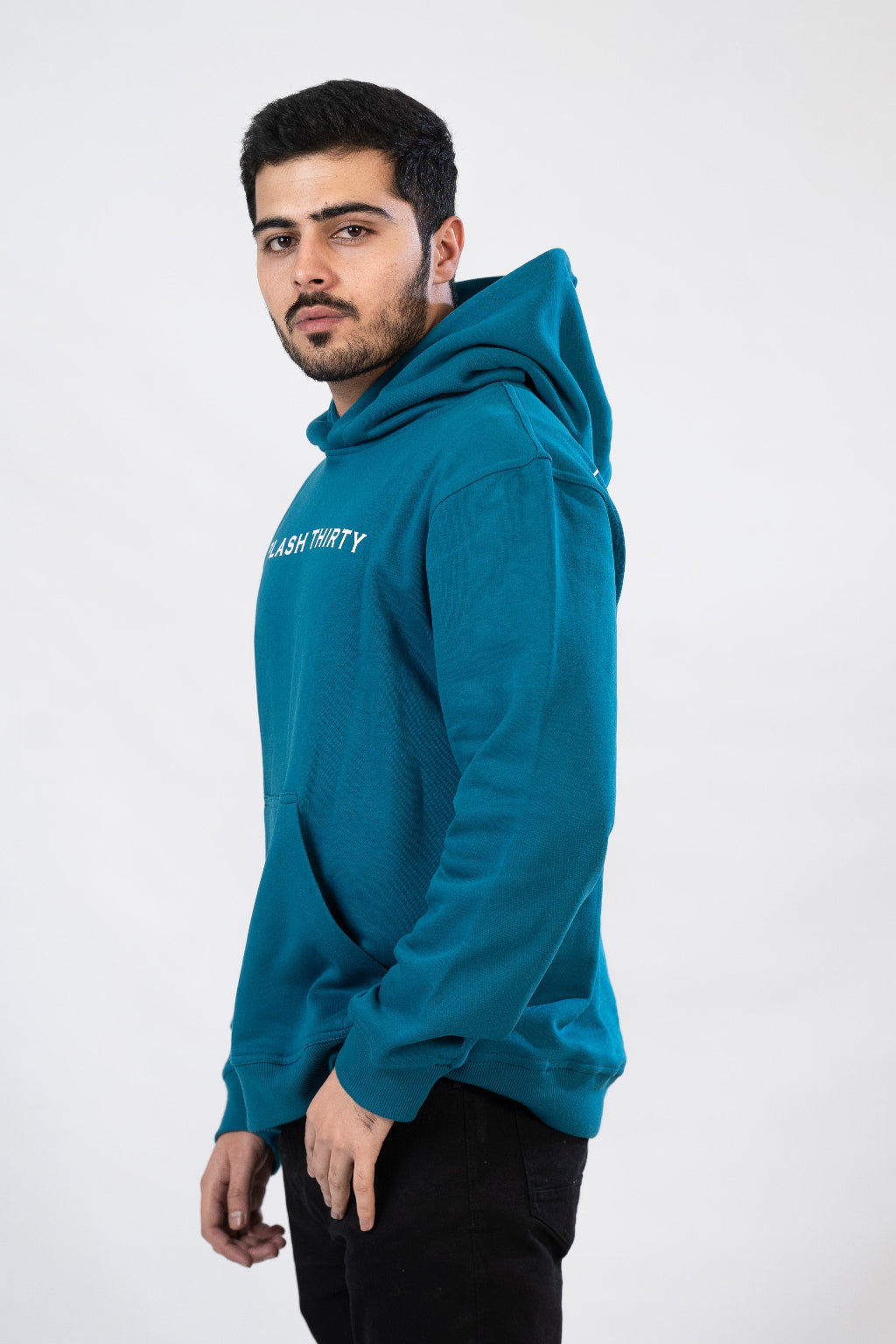 Man wearing a teal hoodie with text on a white background