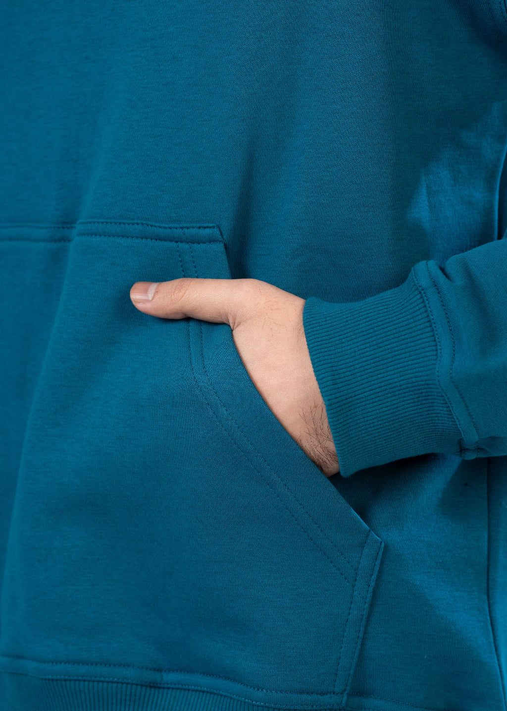 Teal sweatshirt with a hand in the pocket