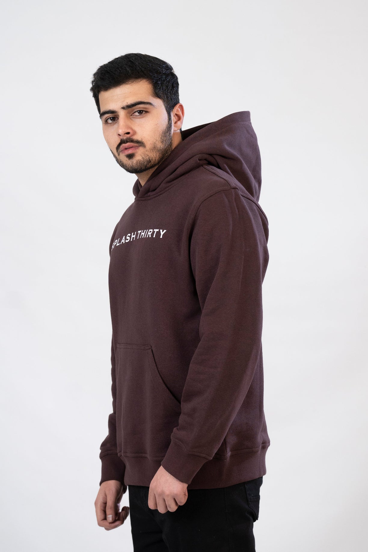 Man wearing a brown hoodie with text on a white background