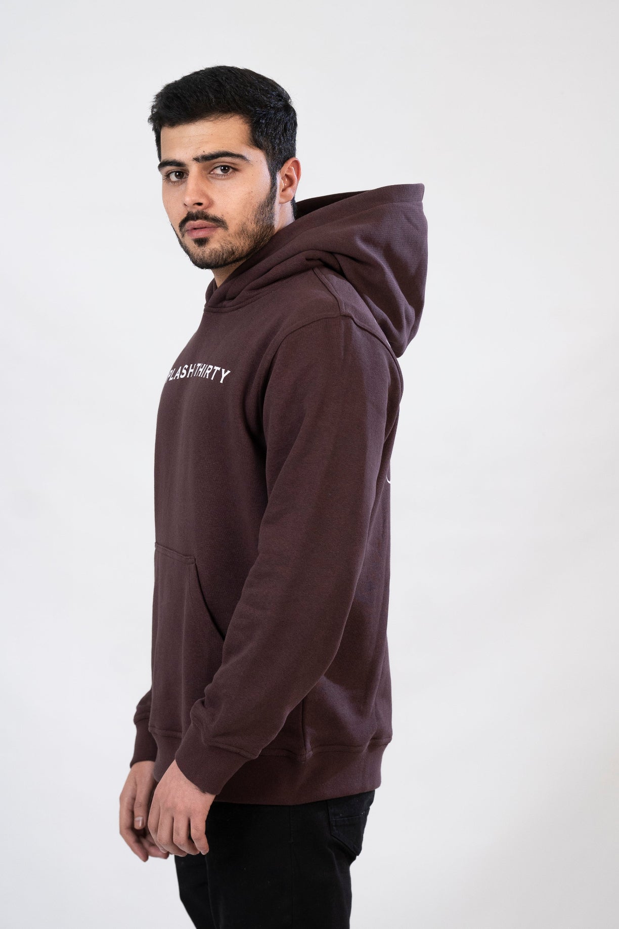 Man wearing a brown hoodie with text on it against a white background