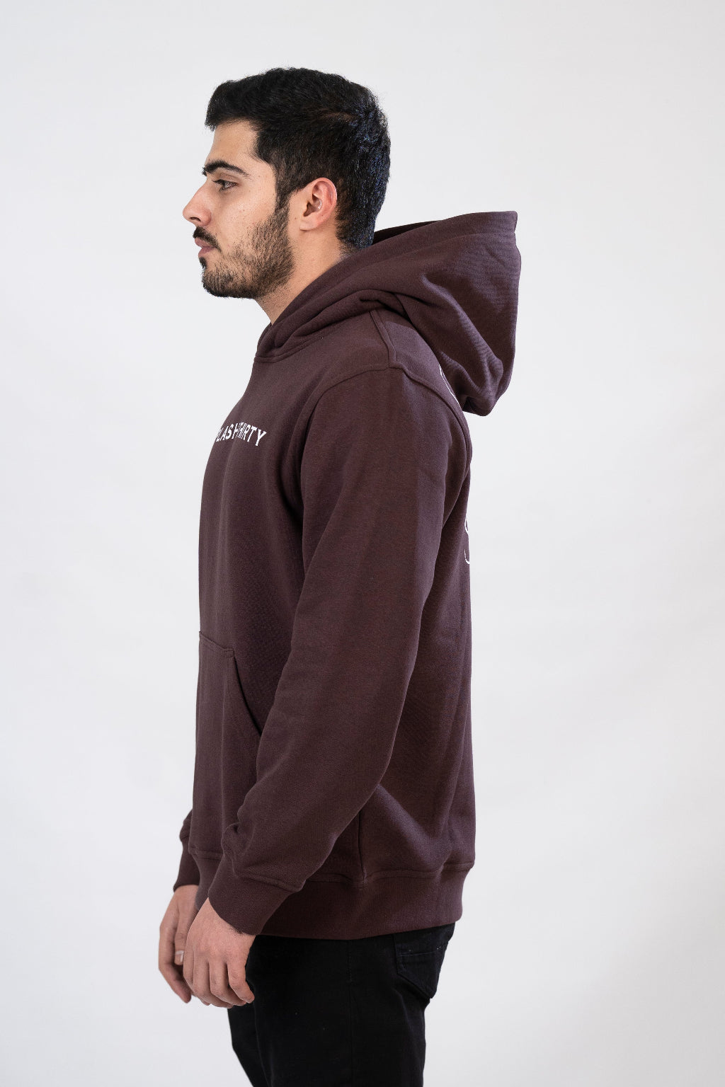 Man wearing a brown hoodie with text on the side against a white background