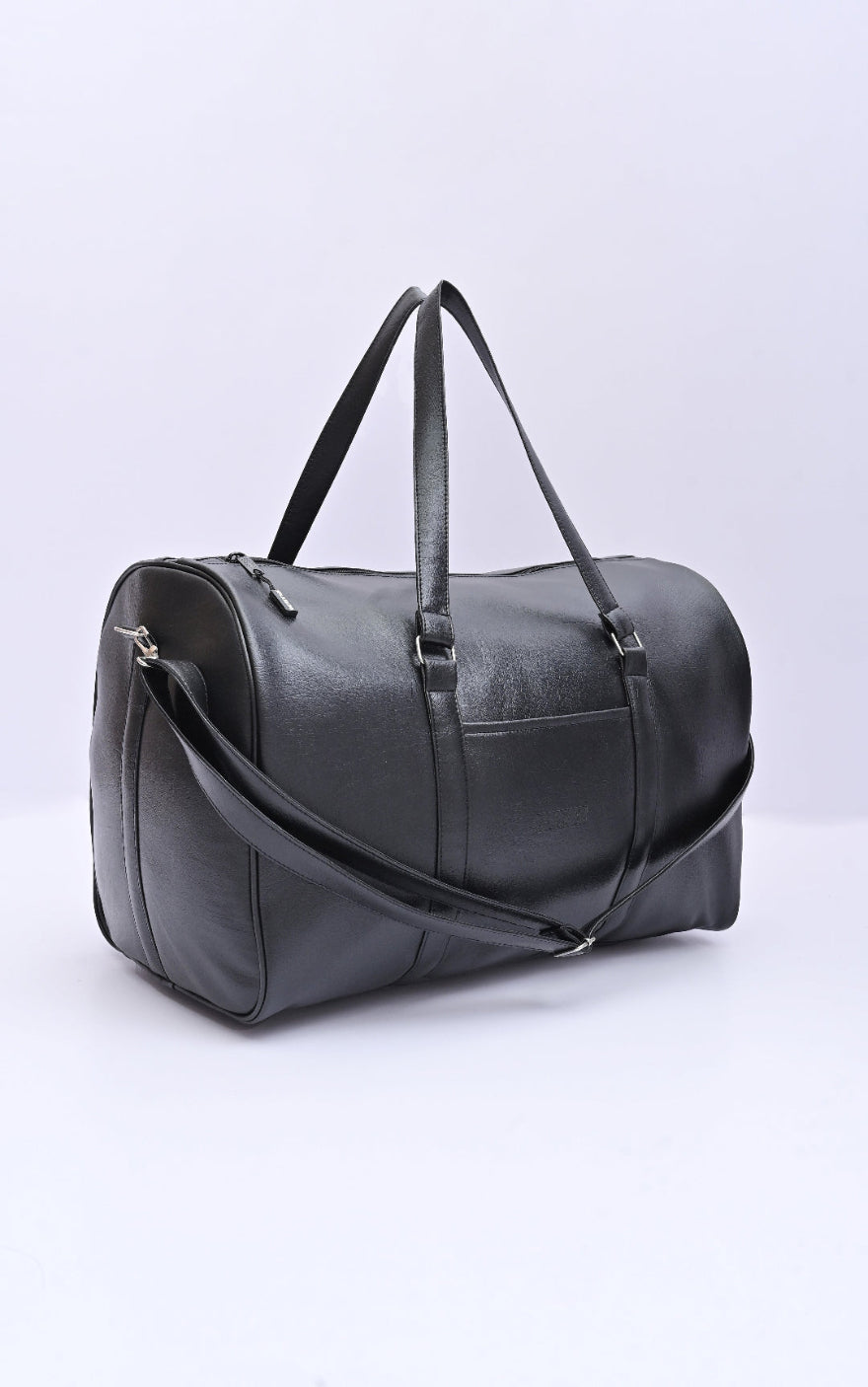 Brown leather duffel bag on a dark background