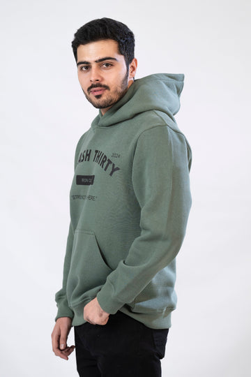 A male model wearing a green hoodie with 'IRON CLUB' text on the front.