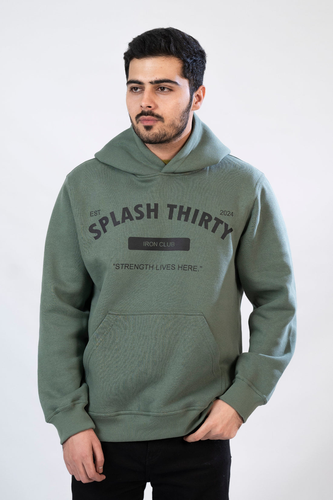 A male model wearing a green hoodie with 'IRON CLUB' text on the front.