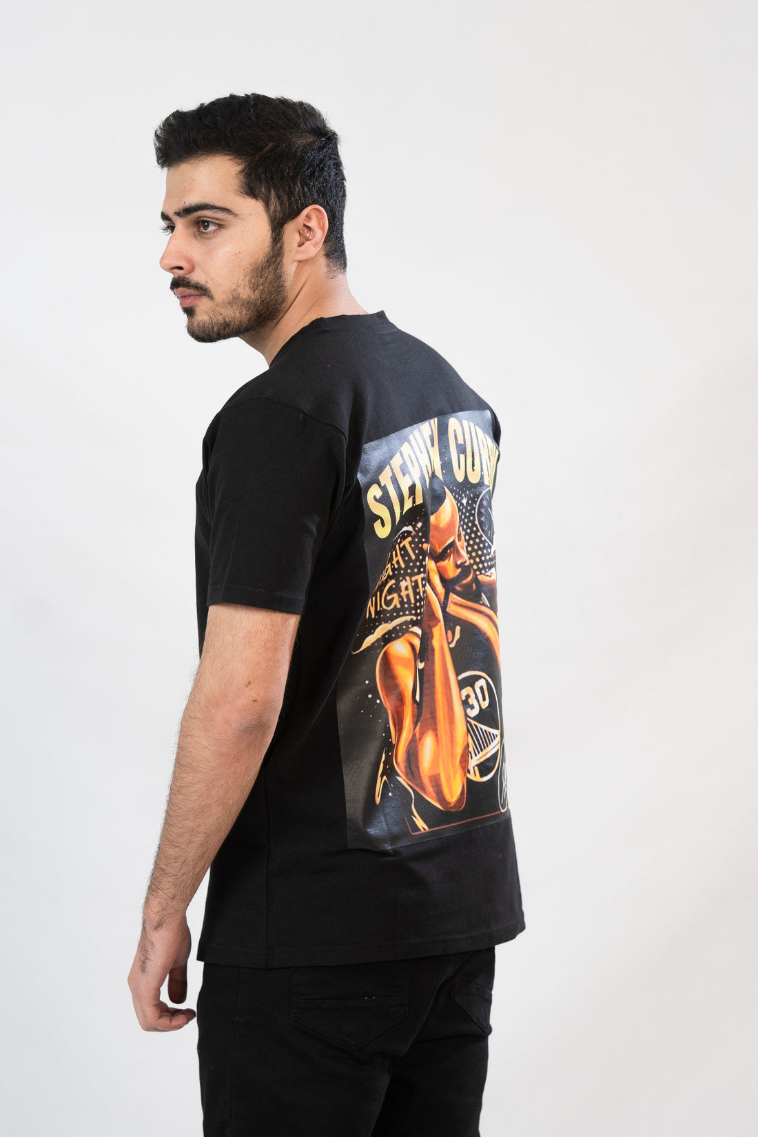 A black t-shirt with a front graphic print of the basketball player Stephen Curry, with the text 'Stephen Curry' and the number '30' included.