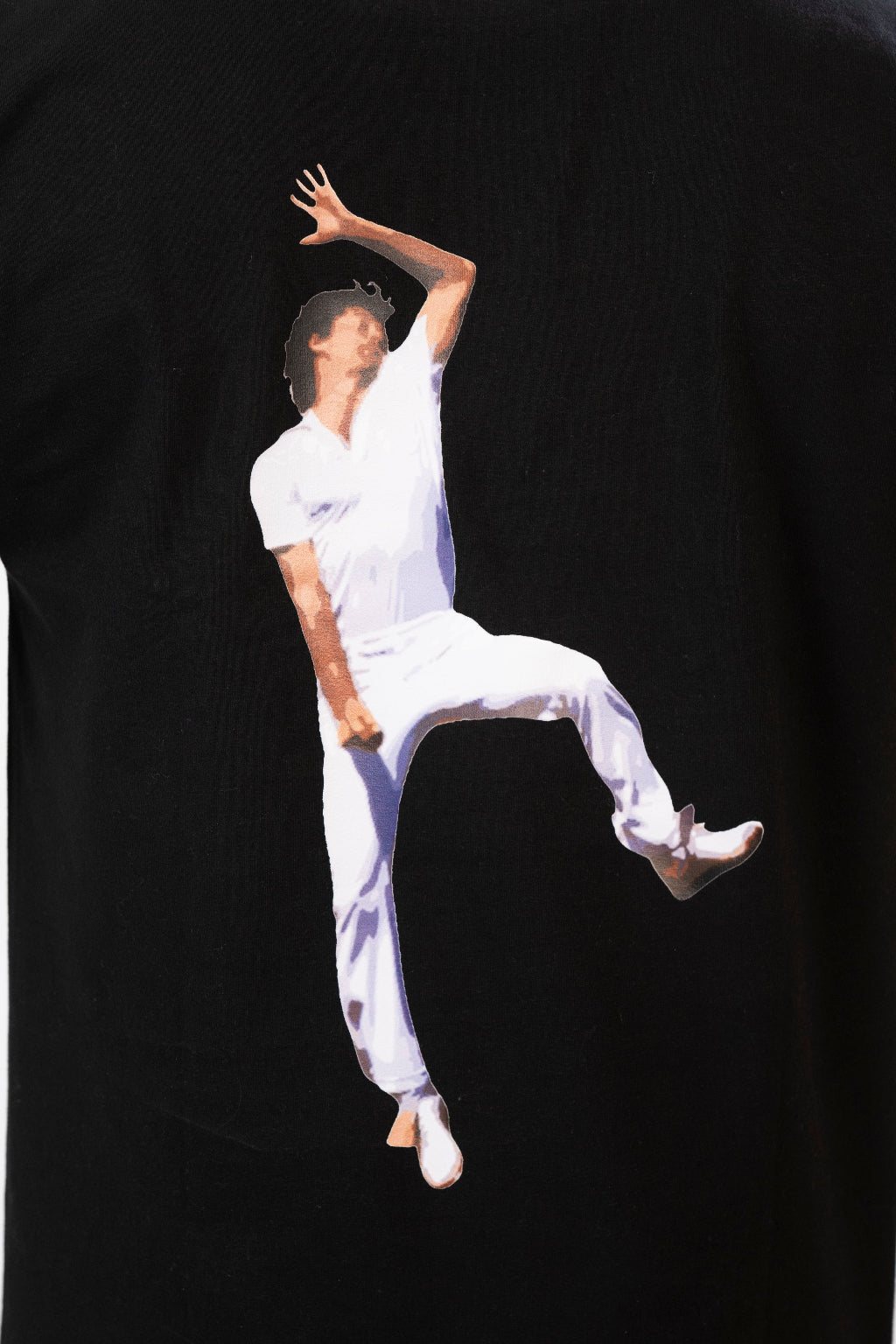 Black t-shirt with a graphic of a person in white clothing leaping on a black background