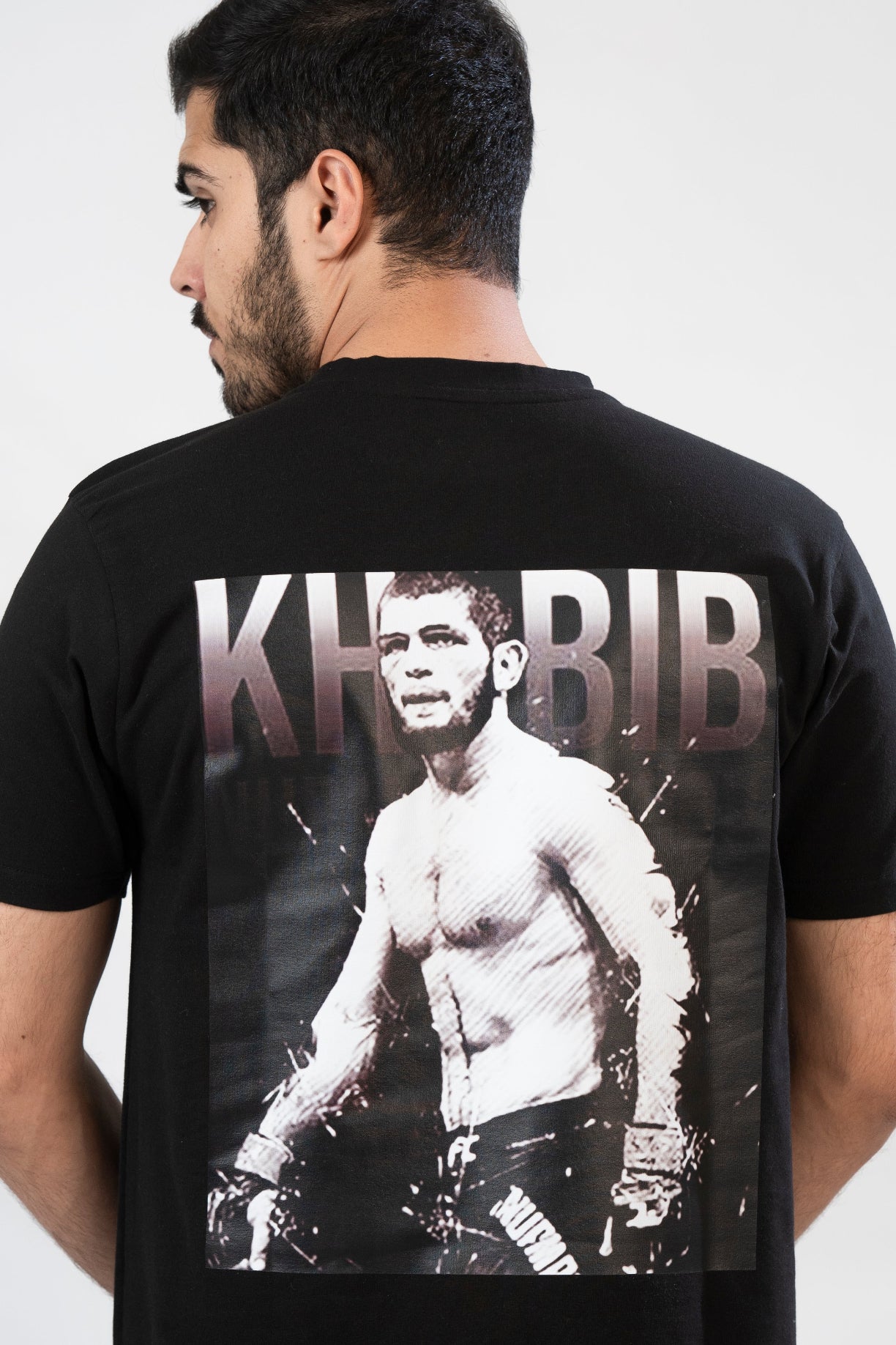 A man wearing a black t-shirt with a print of Khabib on the front.