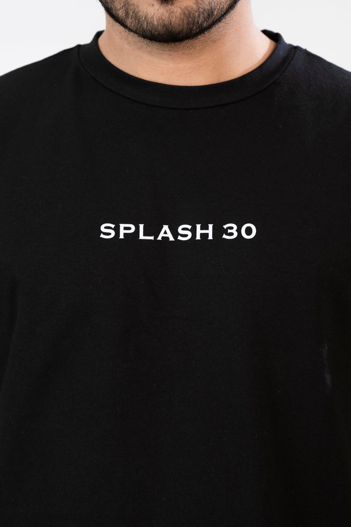 Black t-shirt with 'SPLASH 30' text on a plain background