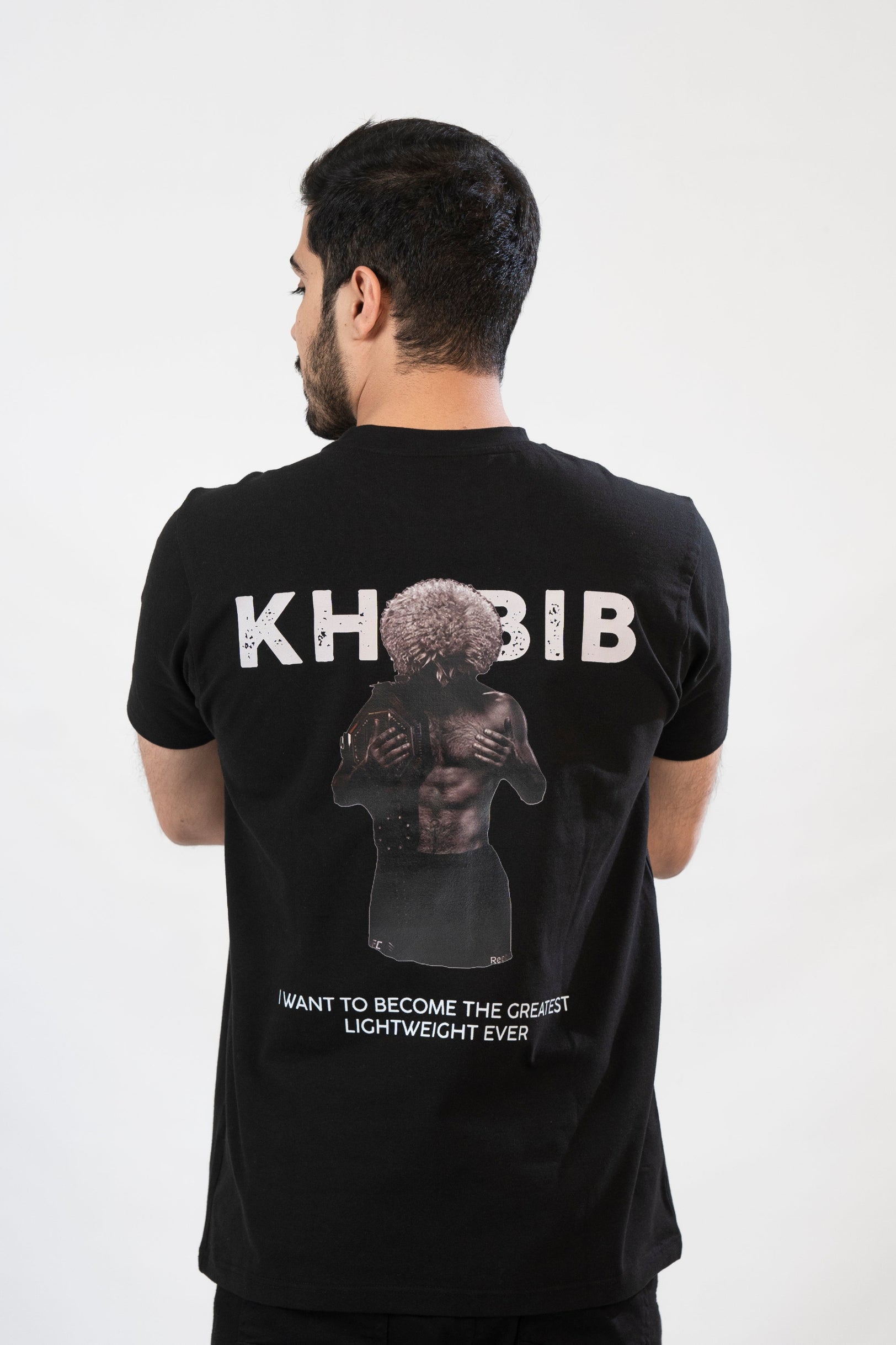Man wearing a black t-shirt with 'KHABIB' and a graphic of a person on the back.