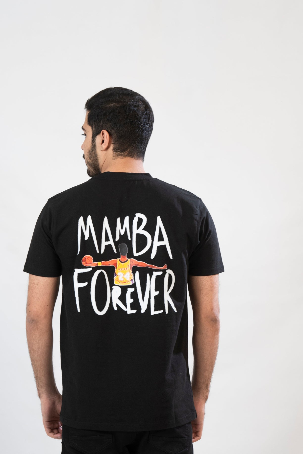 Person wearing a black t-shirt with 'Mamba Forever' text and graphic on the back.