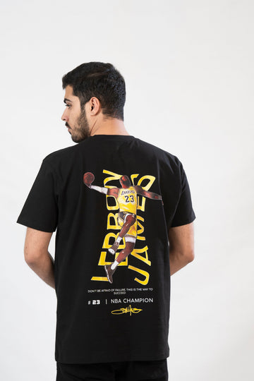 A man wearing a black t-shirt with a graphic print of LeBron James and the text 'LEBRON JAMES' on the front.