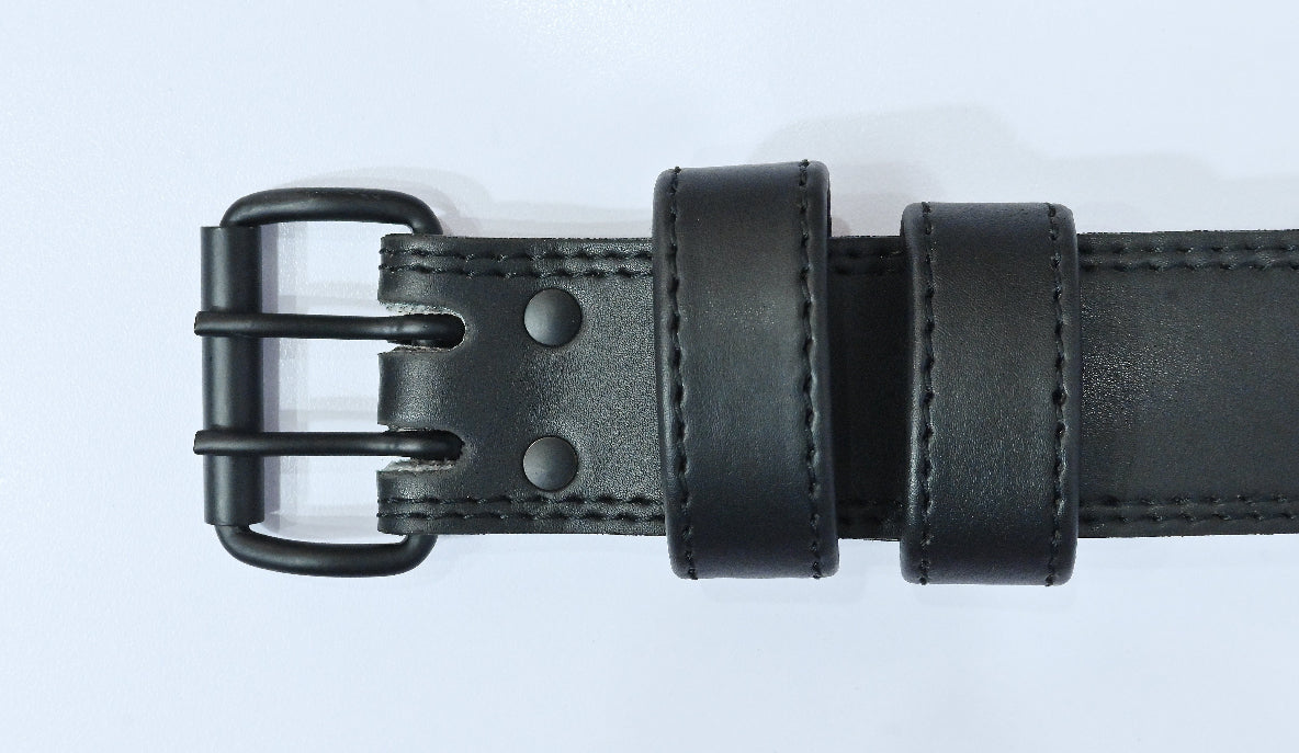 Black leather belt with a metal buckle on a white background