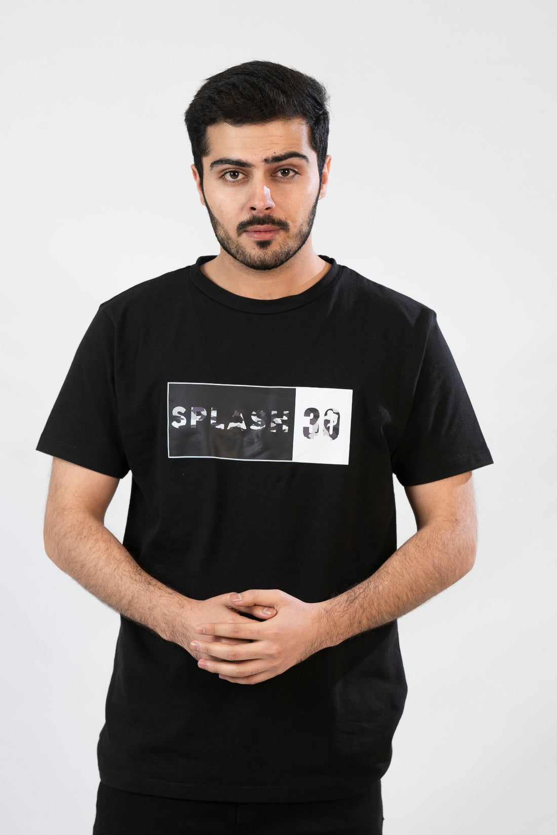 A male model wearing a black t-shirt with 'Splash 30' printed on the front.