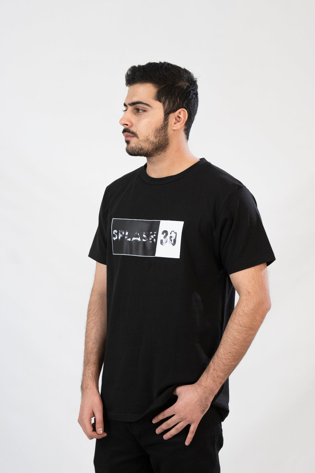 A male model wearing a black t-shirt with 'Splash 30' printed on the front.