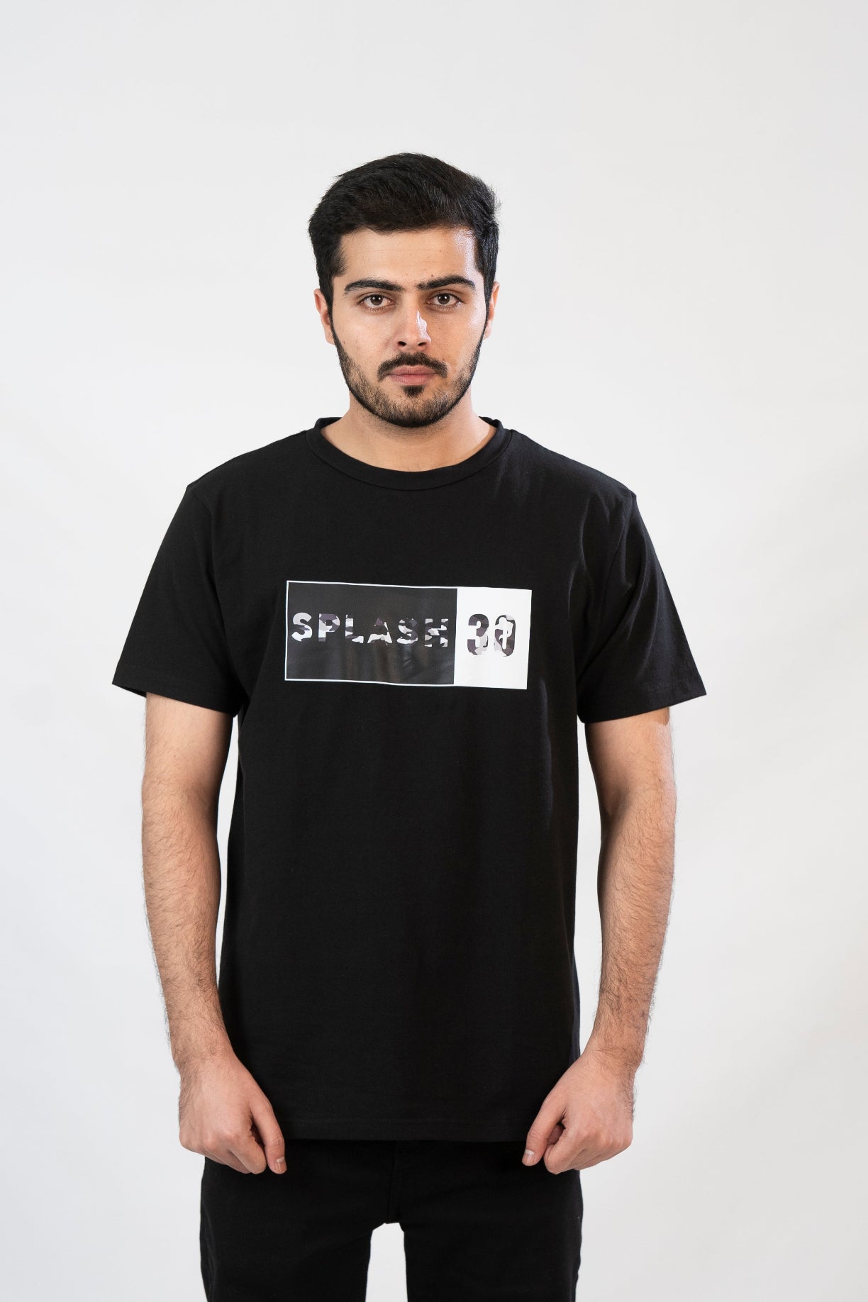 Man wearing a black t-shirt with a logo on a white background
