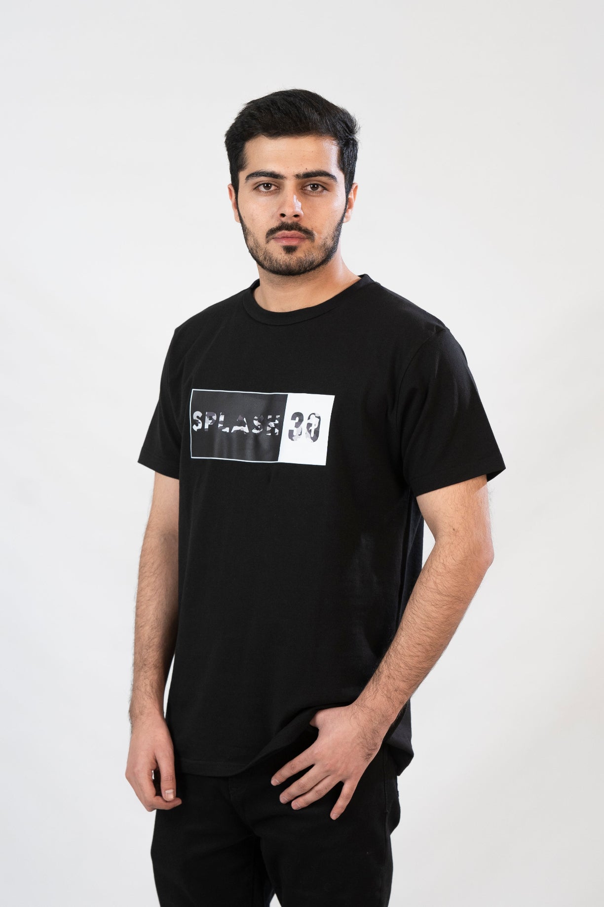 Man wearing a black t-shirt with a graphic design on a white background