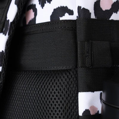 Close-up of a black strap with a patterned fabric background