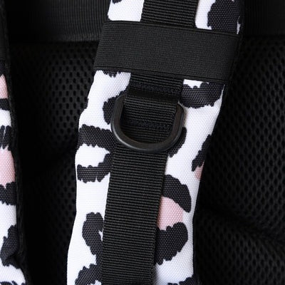 Close-up of a black and white patterned bag with a black strap and buckle.