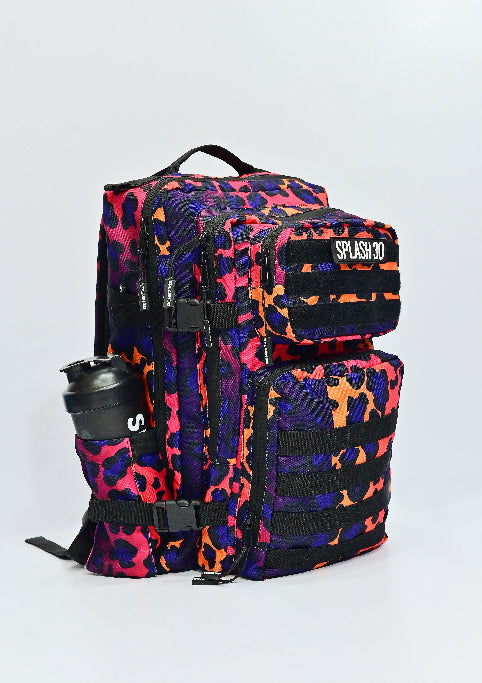 Multicolored camouflage backpack with a black tumbler on a light gray background