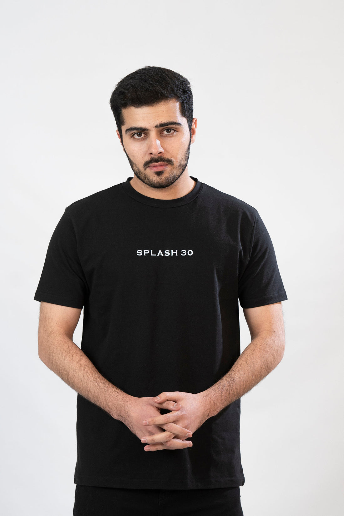 Man wearing a black t-shirt with 'SPLASH 30' text on a white background
