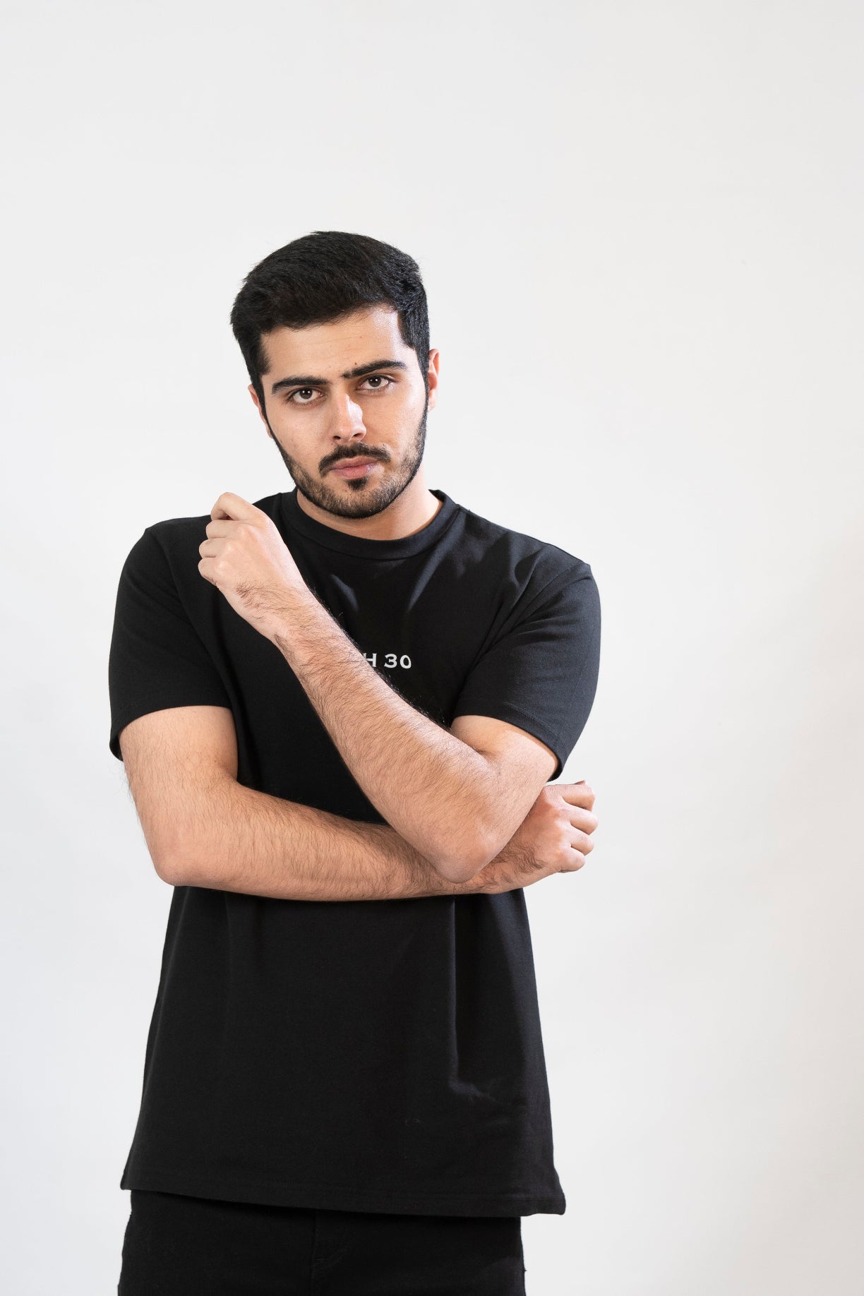 Man wearing a black t-shirt with text on a white background