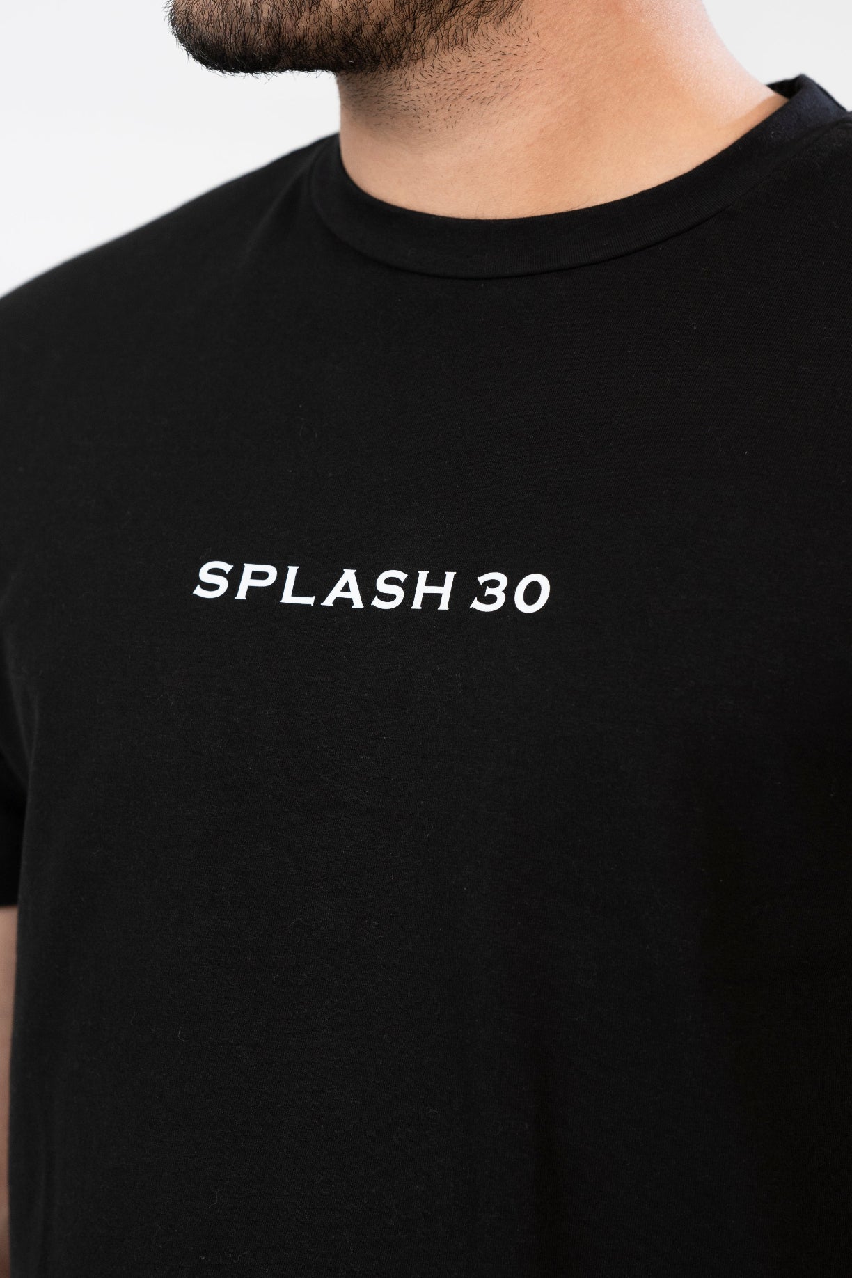 Black t-shirt with 'SPLASH 30' text worn by a person