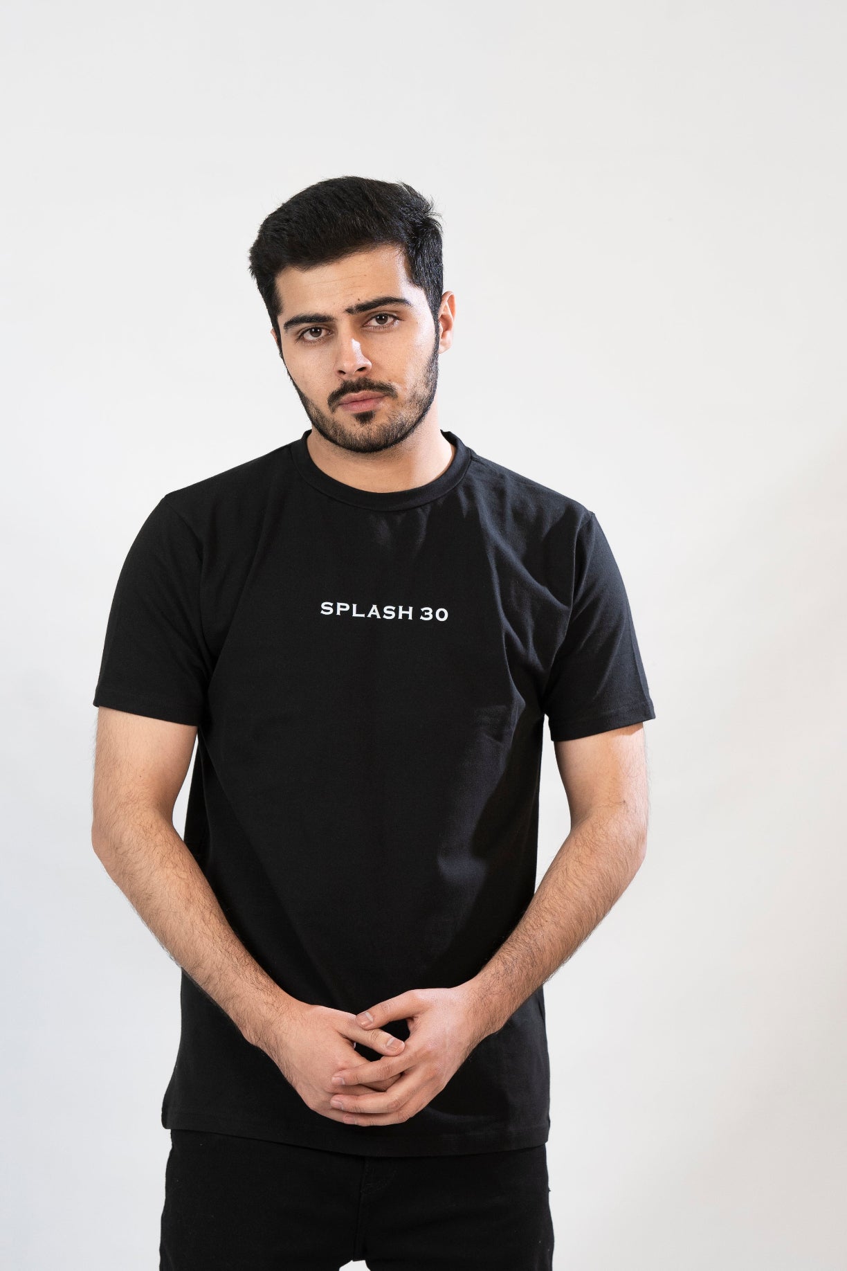 Man wearing a black t-shirt with 'Splash 30' text on a white background