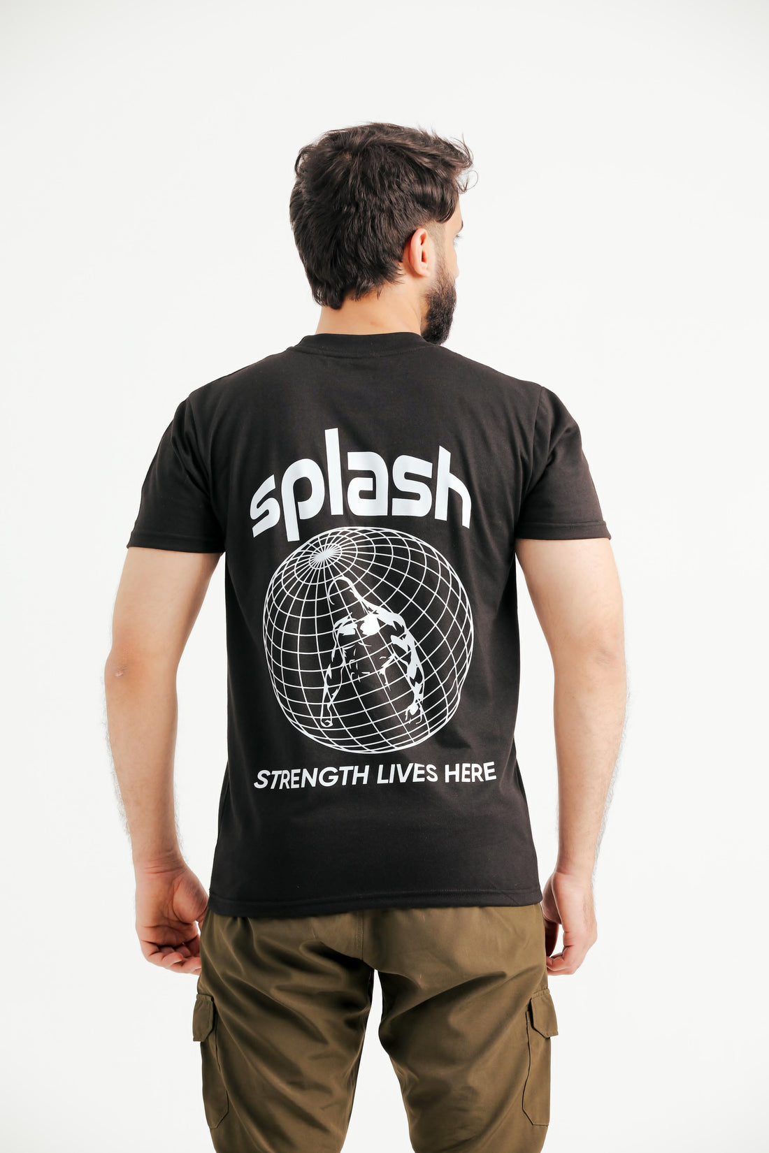 A person wearing a black T-shirt with 'splash' written across the front and the phrase 'strength lives here' around a globe design.