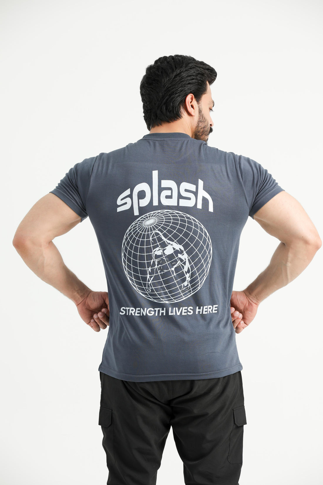 A person wearing a gray t-shirt with the brand name 'Splash' and some graphics on the back.