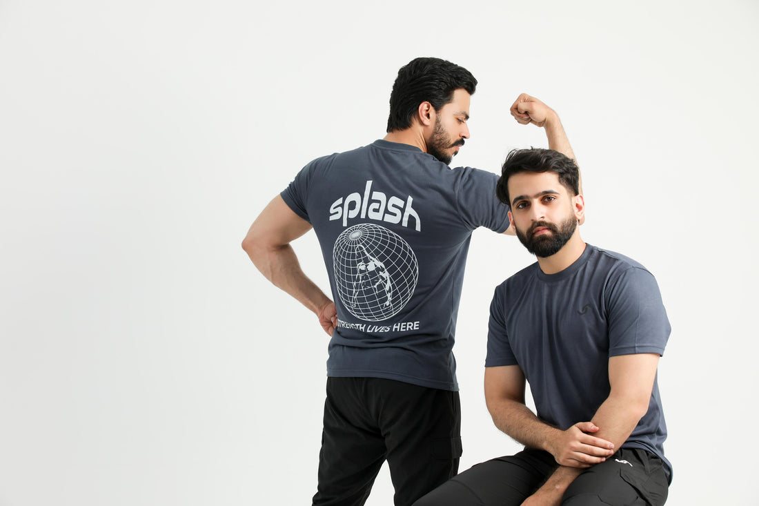 A person wearing a gray t-shirt with the brand name 'Splash' and some graphics on the back.