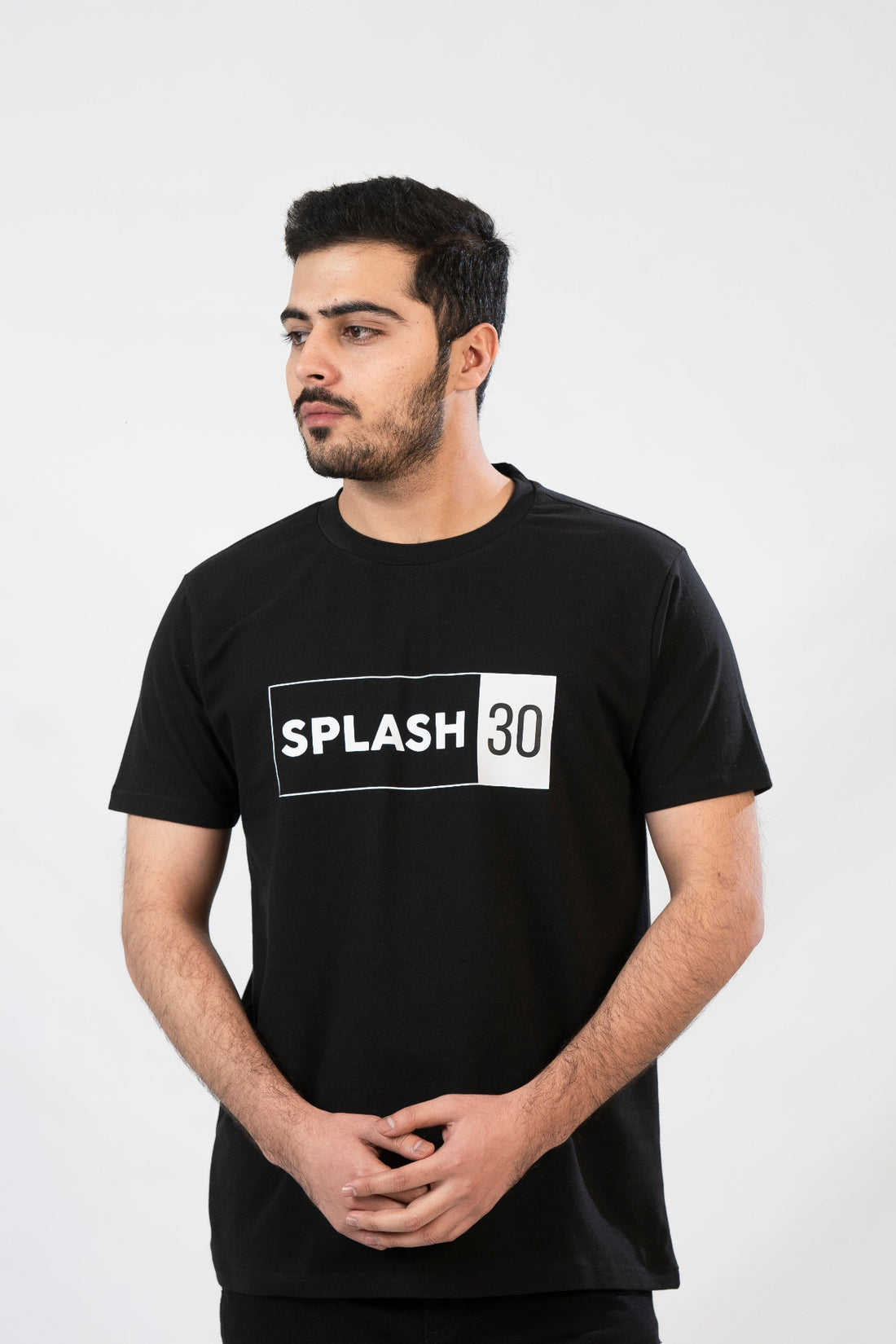 A man standing, wearing a black T-shirt with the text 'Splash 90' printed on the front.