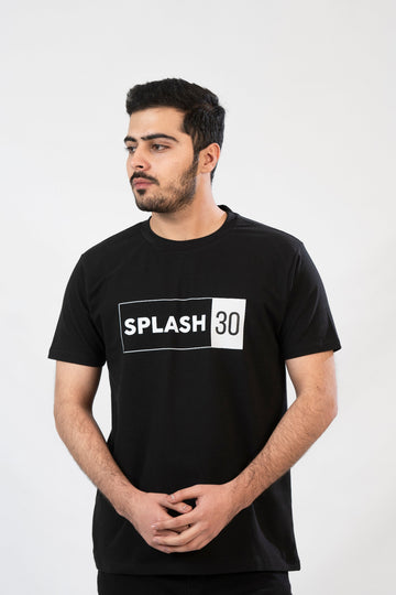 A man standing, wearing a black T-shirt with the text 'Splash 90' printed on the front.