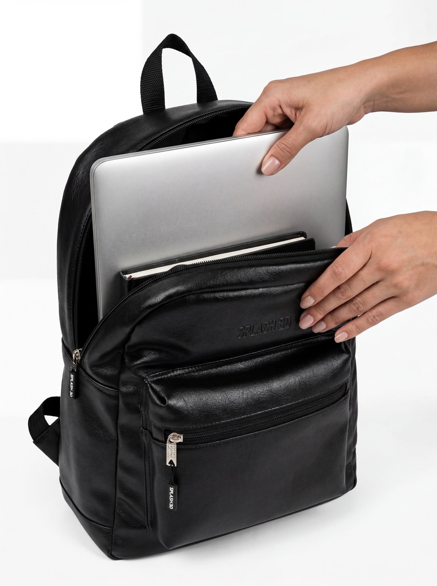 Splash30 Black Leather Backpack 30L with 16 inch laptop being inserted into dedicated sleeve