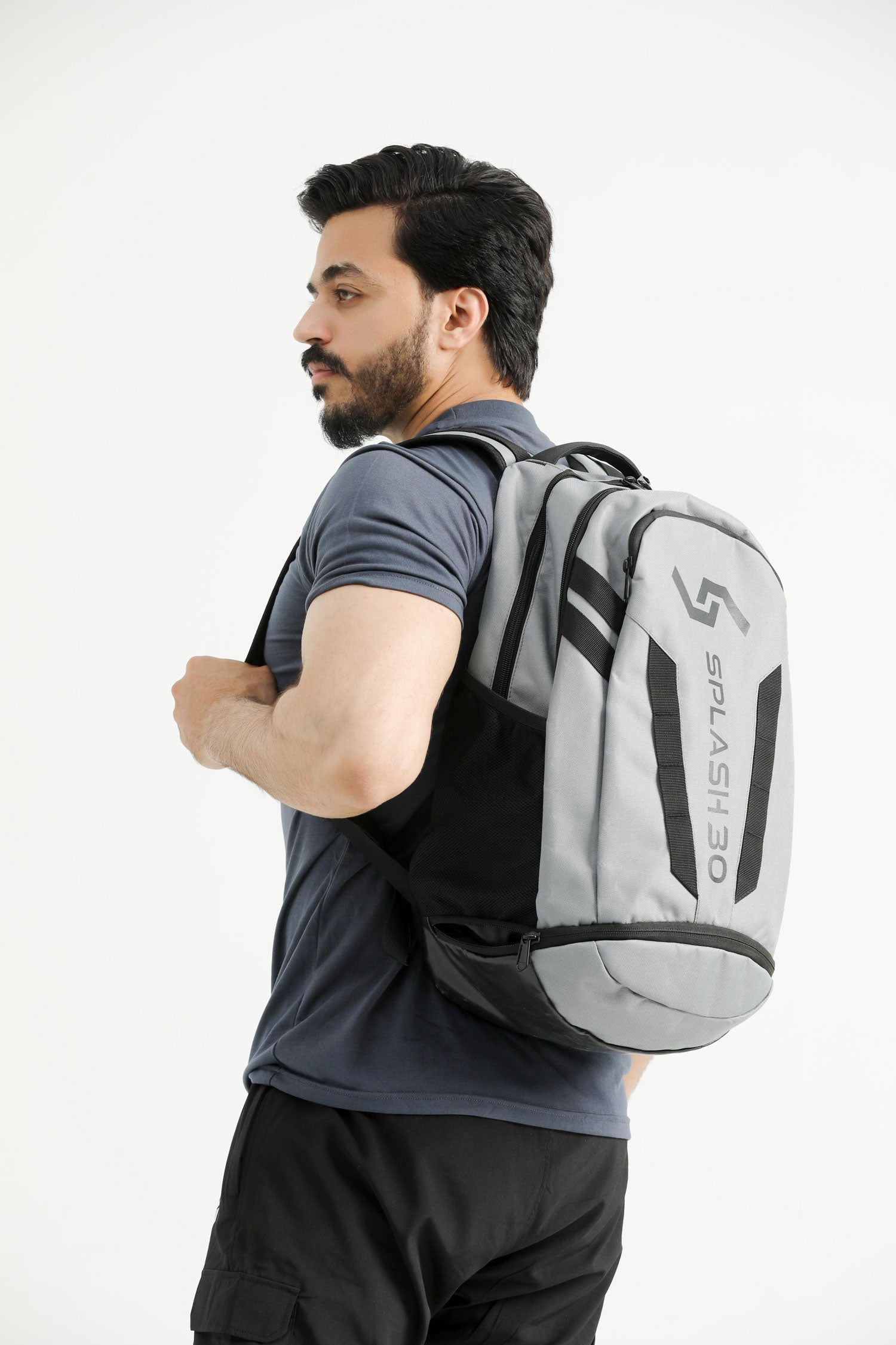 Model wearing the gray Splash 30 Everyday backpack over the shoulder, side view showing the bottle pocket and Splash logo