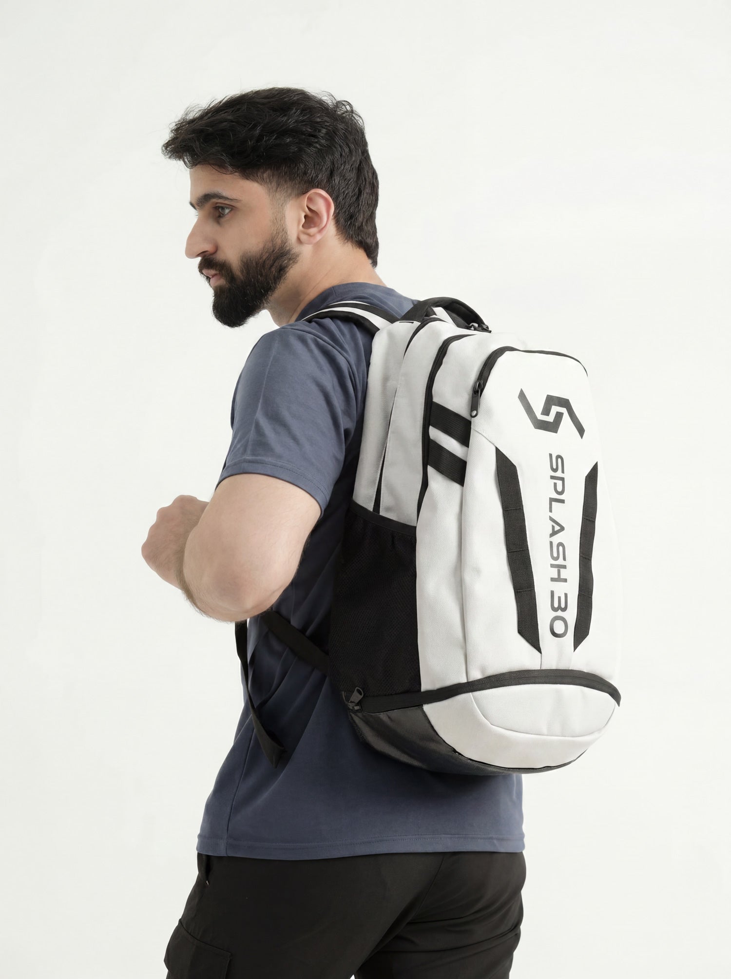 Model wearing the white Splash 30 Everyday backpack with black logo, shown on the back over the shoulder