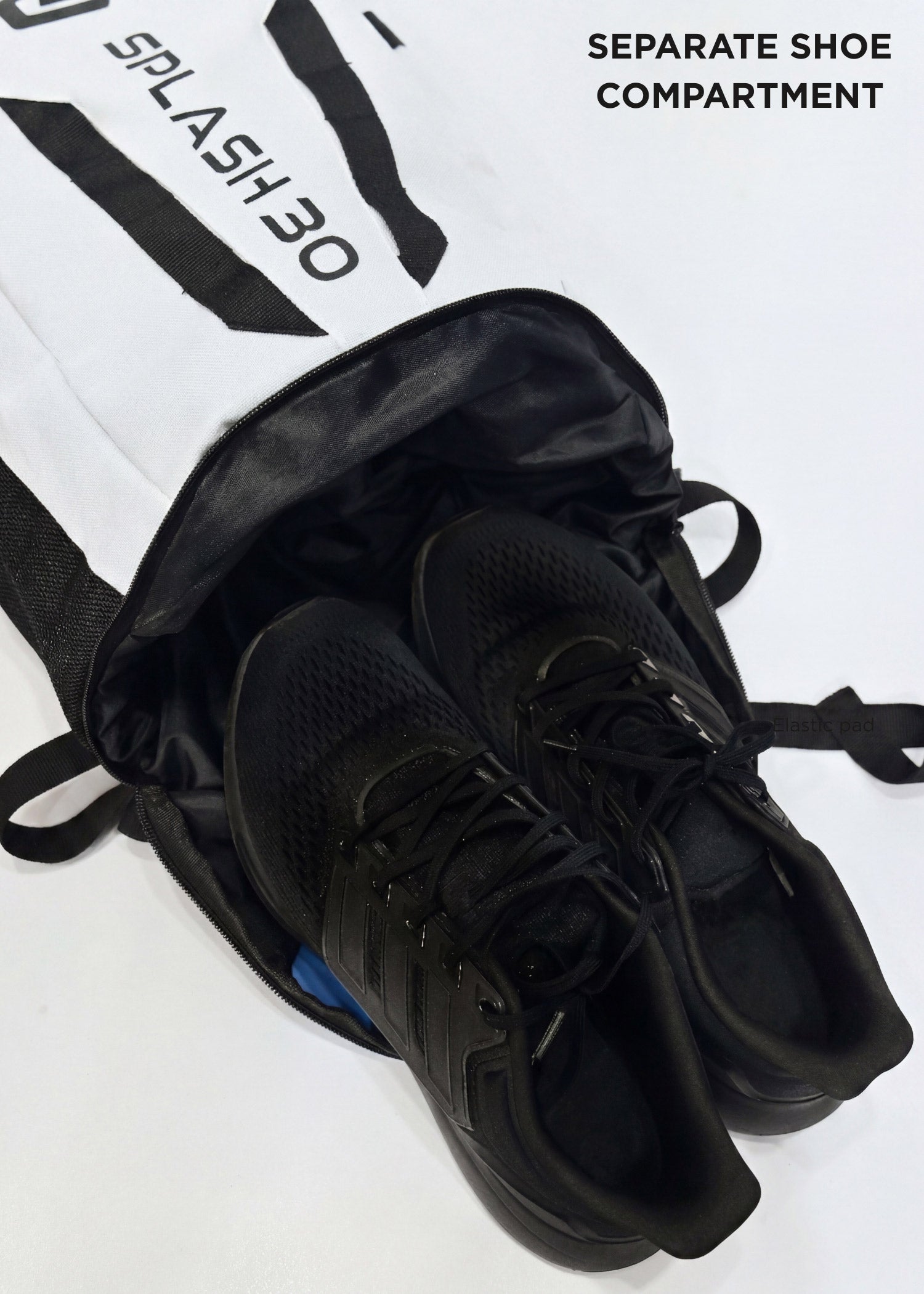 White Splash 30 Everyday backpack with shoes stored in the separate shoe compartment — a dedicated pocket for shoes or laundry