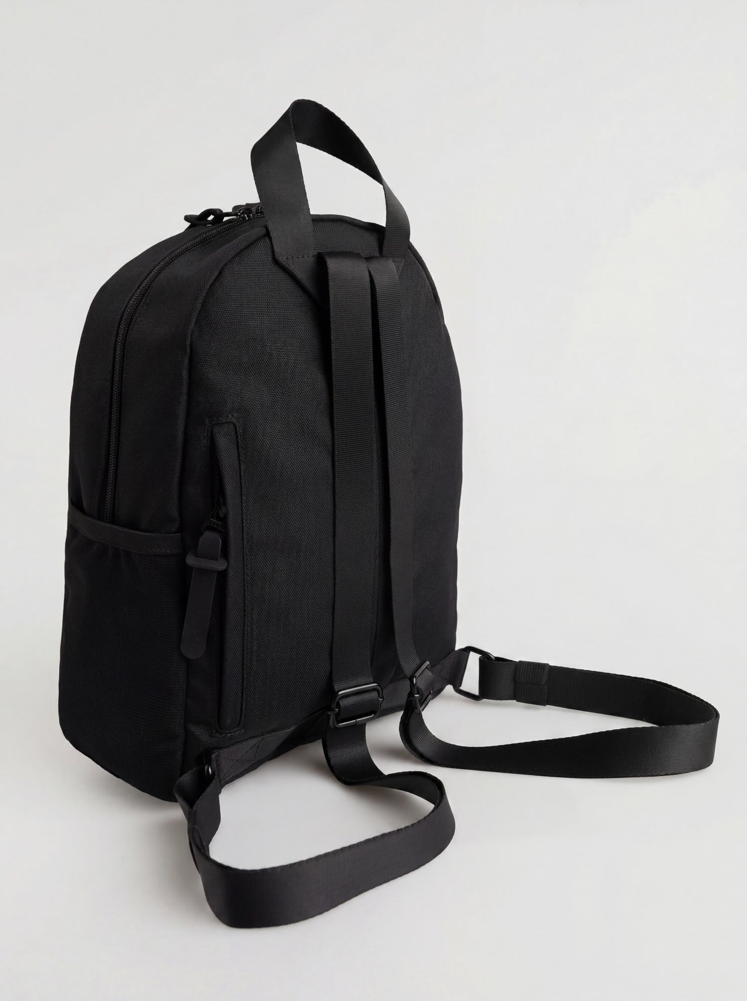 Splash30 Everyday Mini Backpack 8L black side view showing split side pocket