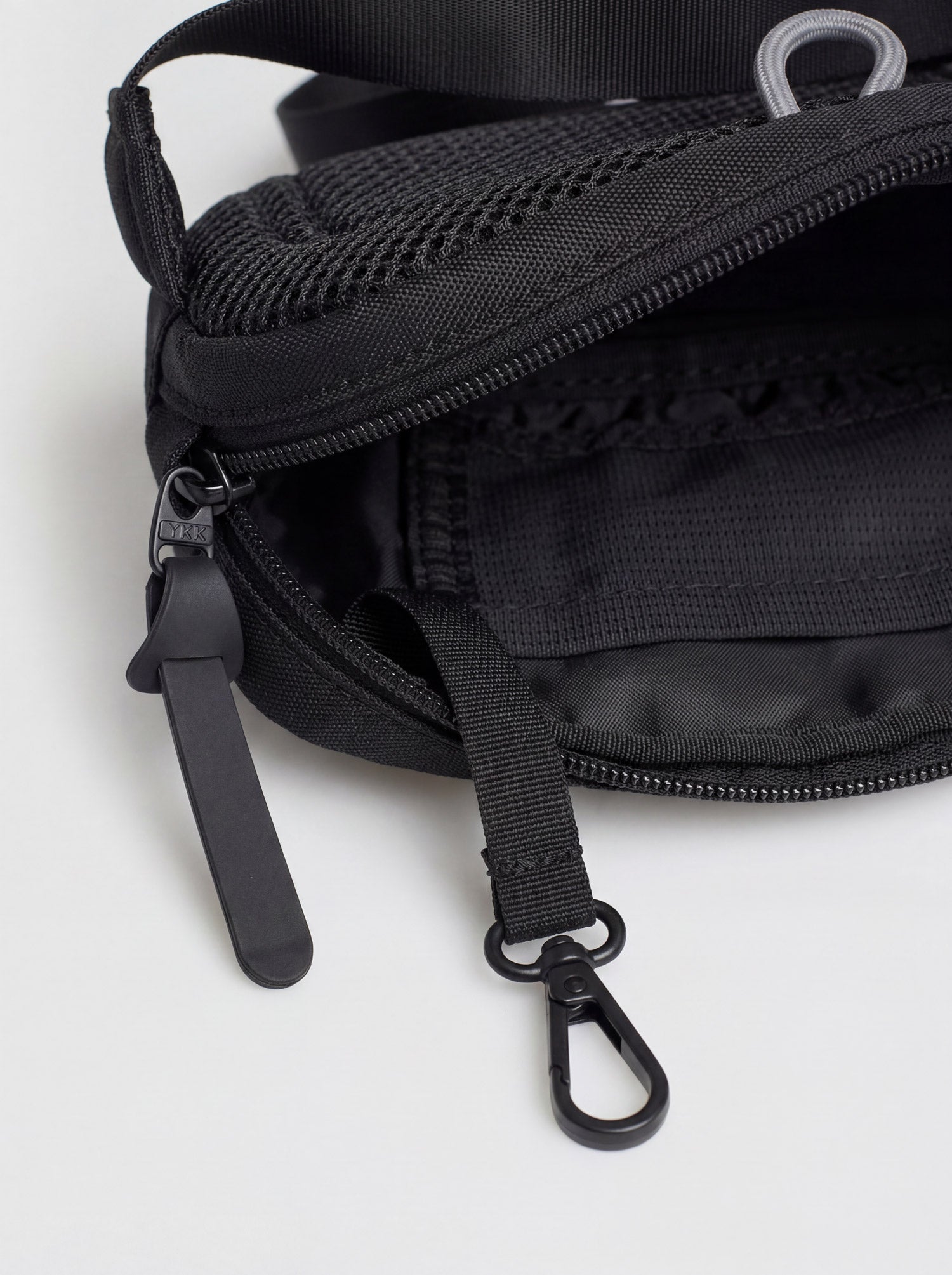 Close-up of metal clasp and zipper detail on Splash30 Everyday Waist Pack black