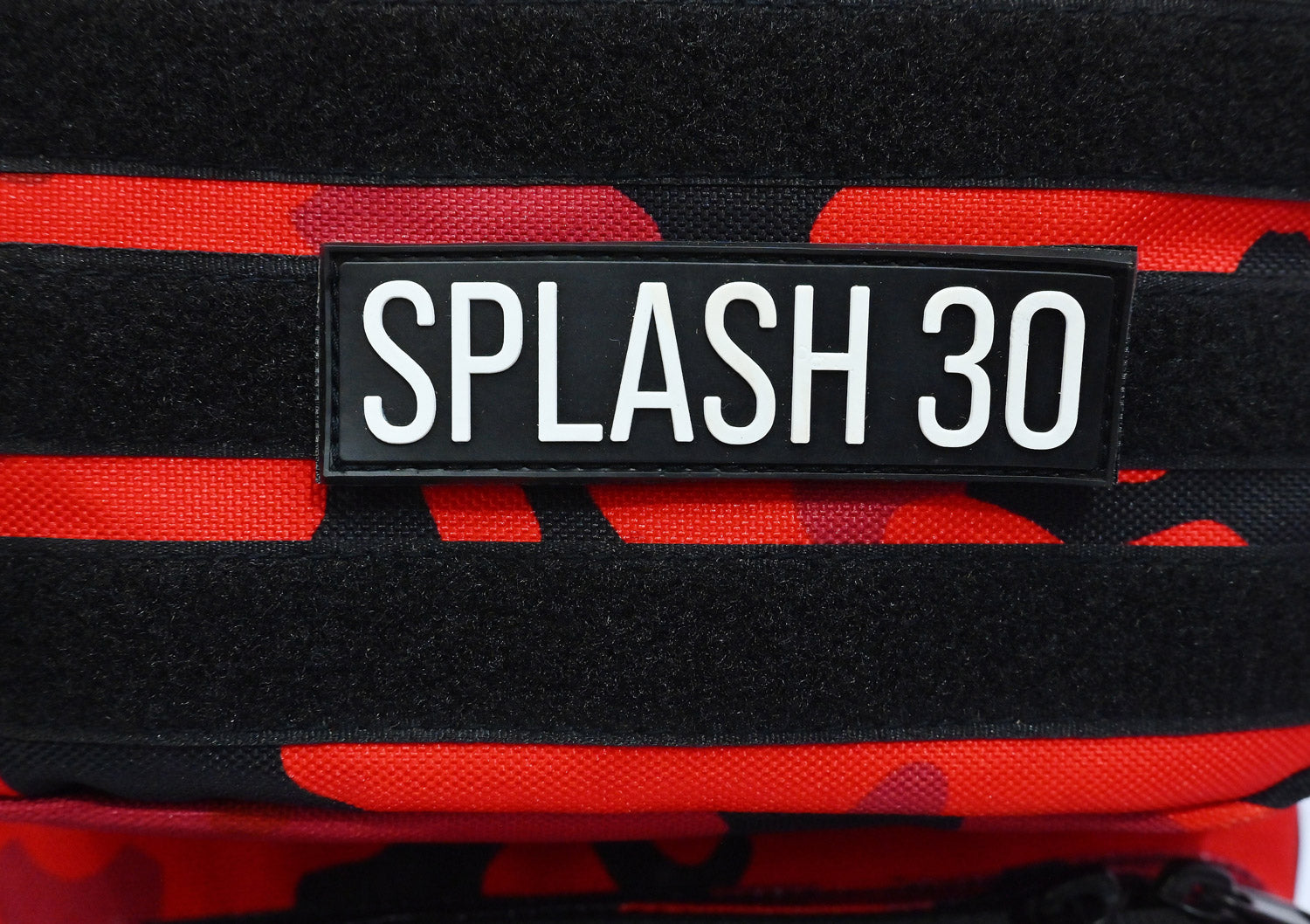 Splash30 logo and branding detail on red camo tactical backpack 45L