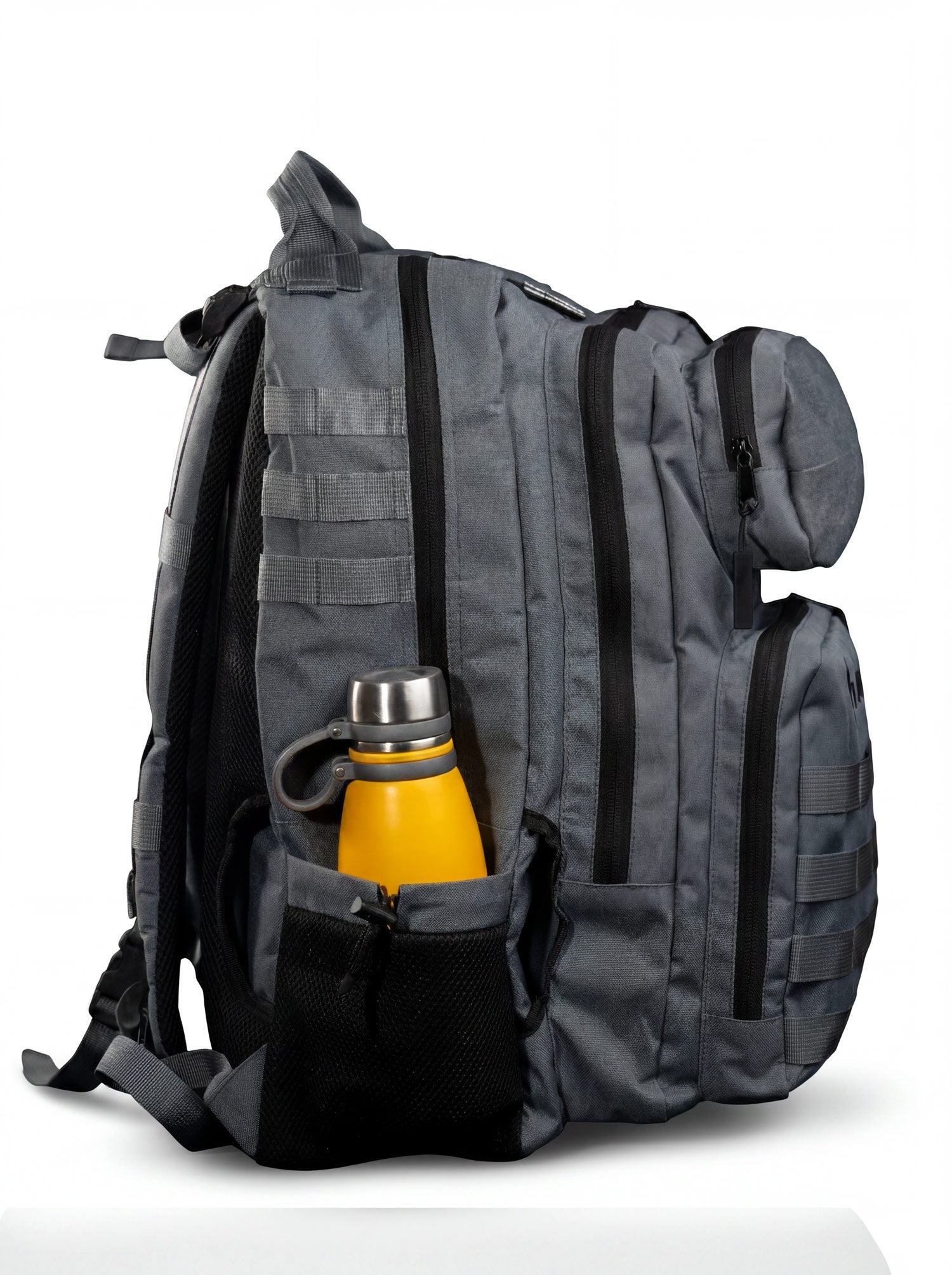 Side profile of the gray tactical backpack showing the full MOLLE webbing column and structured base