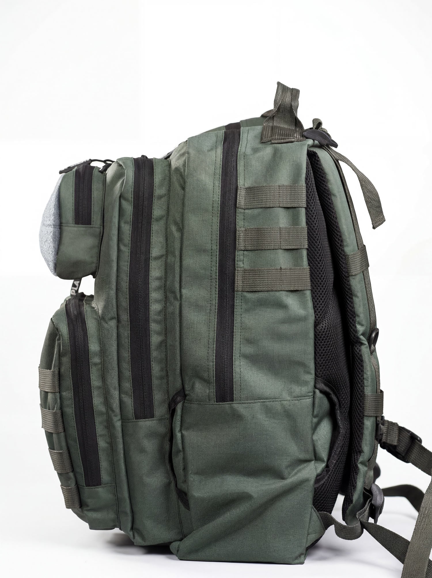 Side profile of the green tactical backpack showing the full MOLLE webbing column and structured base